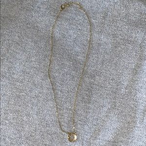 Gold colored compass necklace